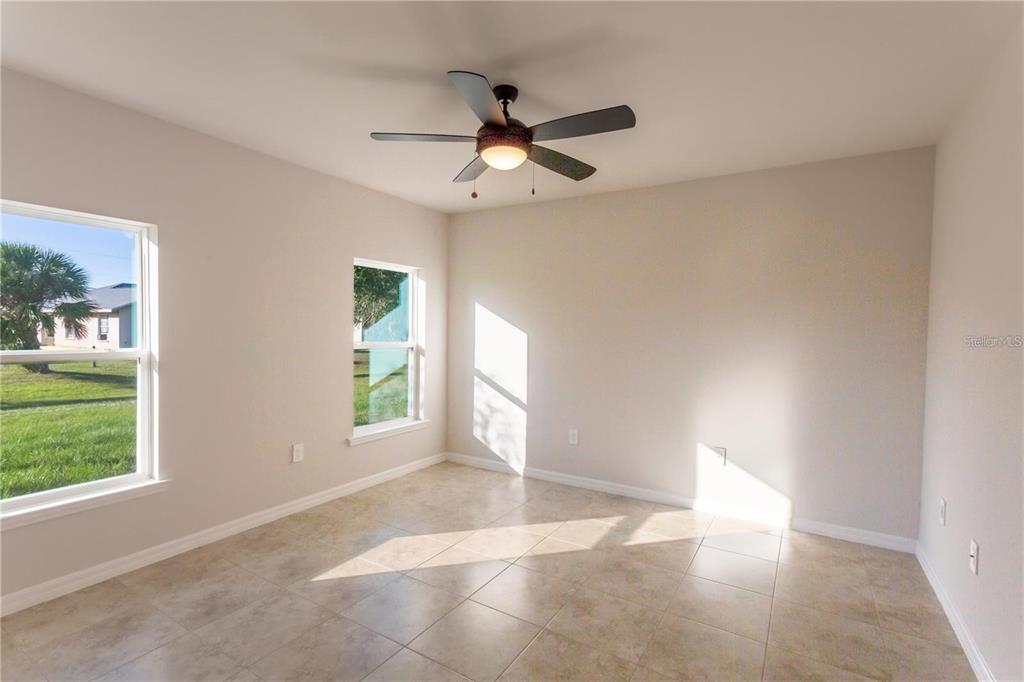 133 Angol Street Punta Gorda, FL 33983 - Photo 12 of 34 an empty room with windows and ceiling fan