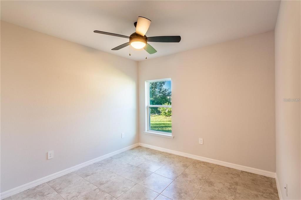133 Angol Street Punta Gorda, FL 33983 - Photo 19 of 34 an empty room with ceiling fan and window