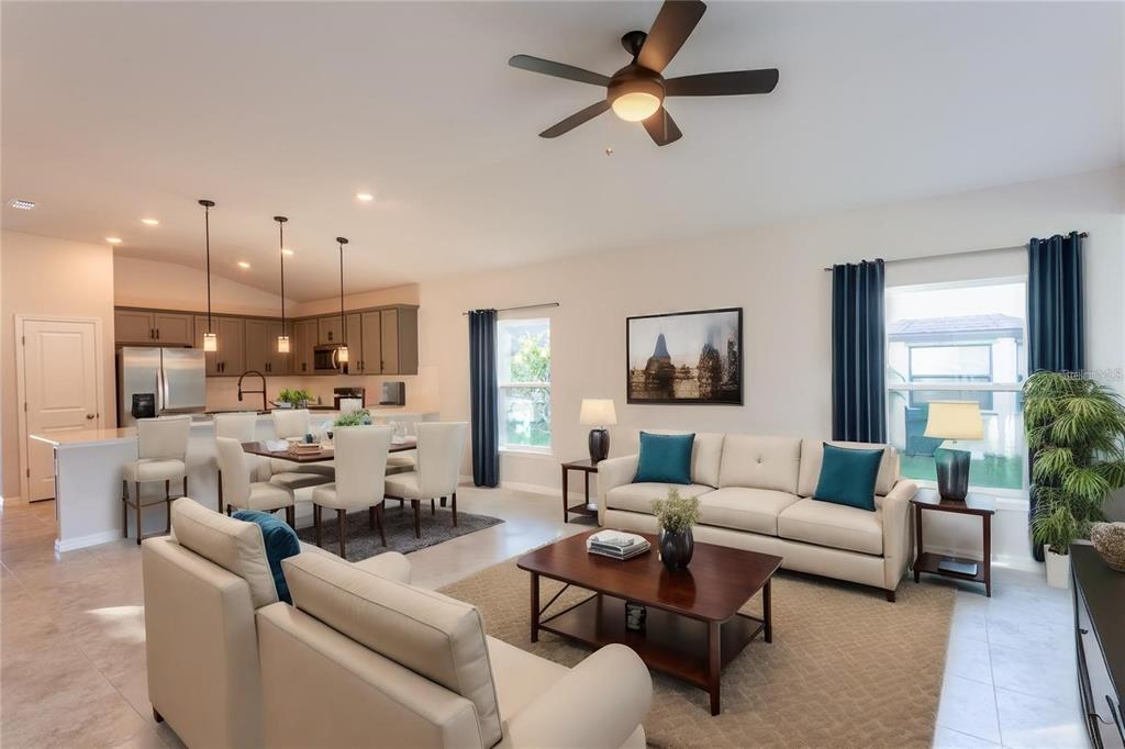 133 Angol Street Punta Gorda, FL 33983 - Photo 25 of 34 a living room with furniture kitchen view and a chandelier