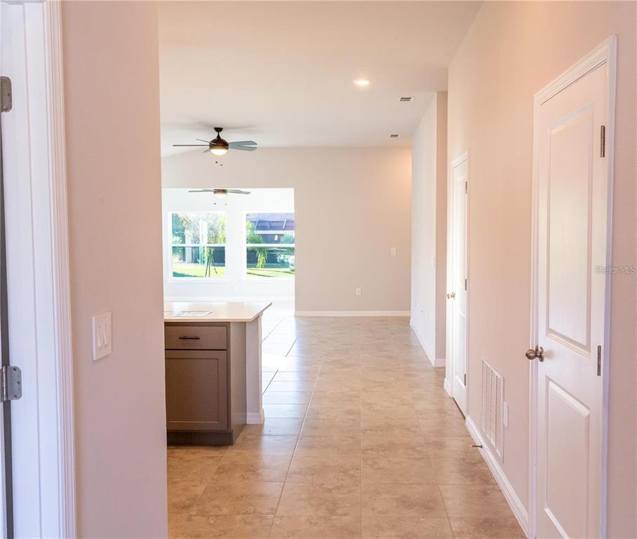 133 Angol Street Punta Gorda, FL 33983 - Photo 3 of 34 a view of hallway with kitchen island and a window