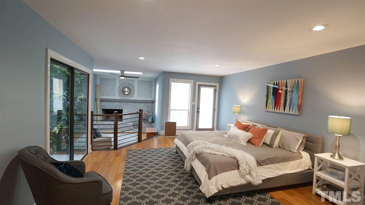 10517 Whitestone Road Raleigh, NC 27615 - Photo 17 of 30 This master bedroom is a true retreat. Spacious room and a sitting area with a fireplace. Doors lead to a private deck area.