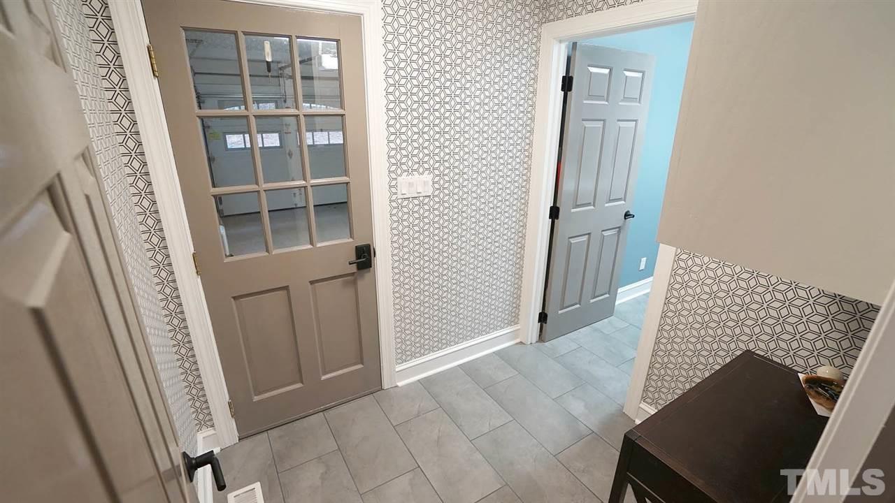 10517 Whitestone Road Raleigh, NC 27615 - Photo 25 of 30 Designer wallpaper in entry from garage. Perfect place to put your keys and drop your mail, bag and shoes.