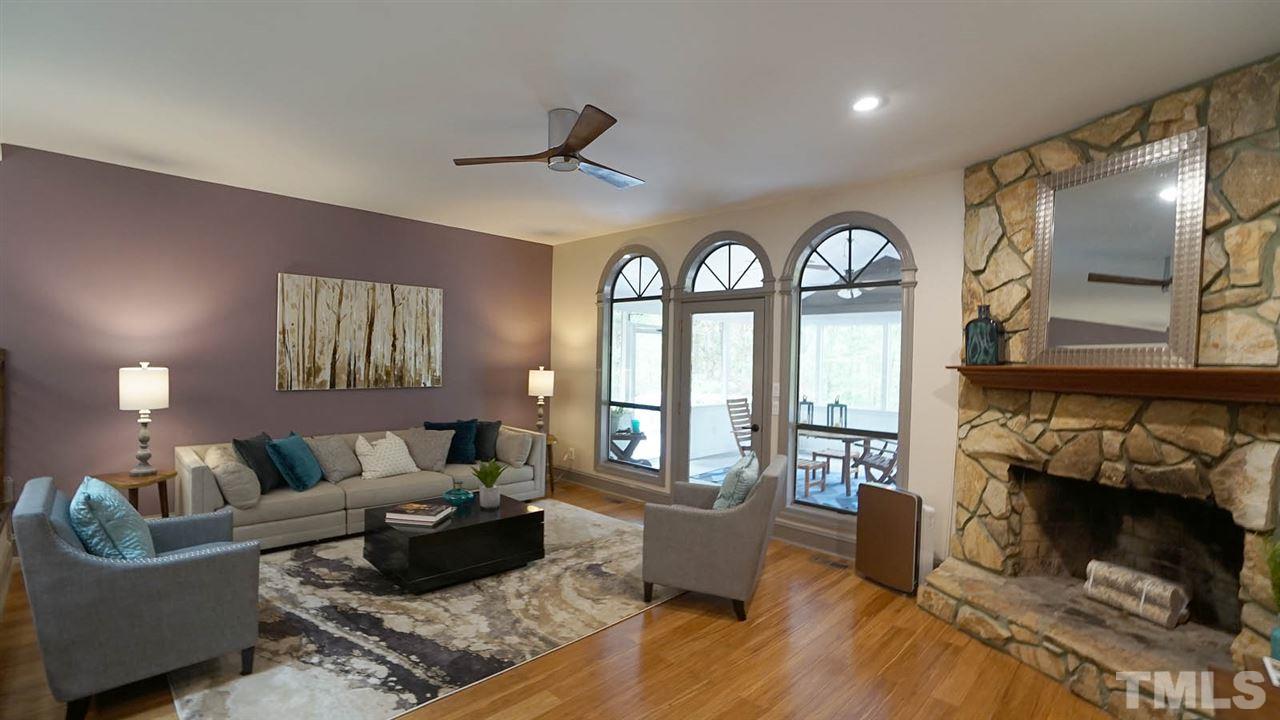 10517 Whitestone Road Raleigh, NC 27615 - Photo 6 of 30 Spacious living room with wood burning fireplace. Opens to screened porch.
