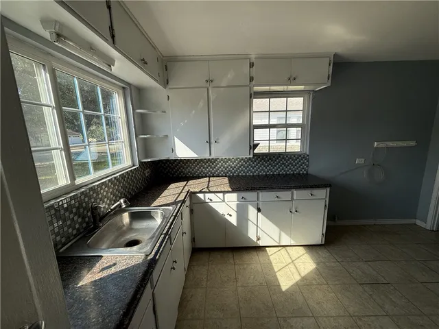 a kitchen with a sink and a stove top oven