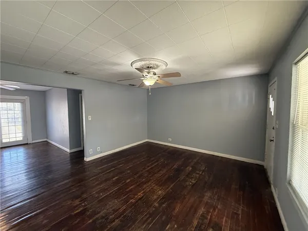 wooden floor in an empty room with a window