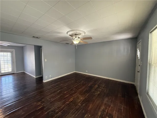 wooden floor in an empty room with a window