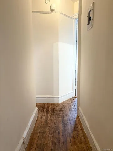 a view of a room with wooden floor