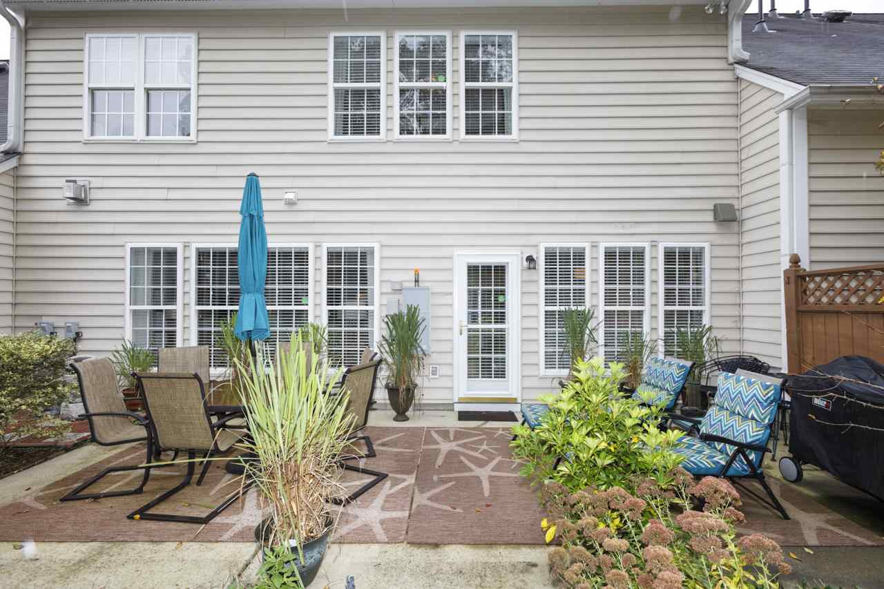 3743 Old Post Road Raleigh, NC 27612 - Photo 24 of 25 Private patio is large enough for a grill, a table for four, some lounge chairs and potted plants! Exterior Back