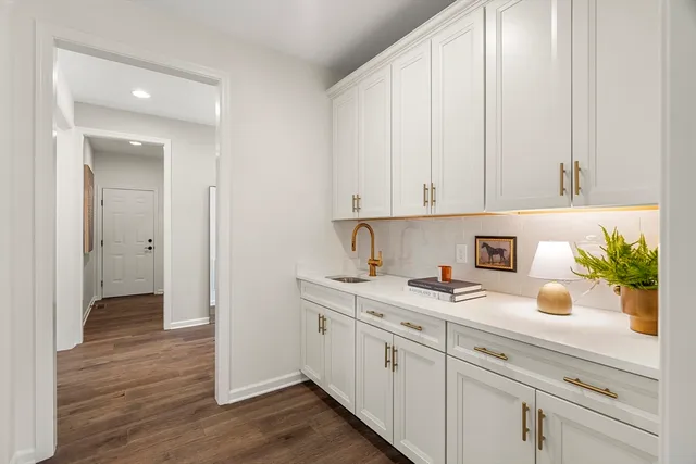 a kitchen with sink and cabinets