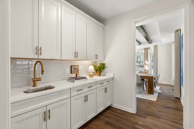 a dining room with furniture and wooden floor