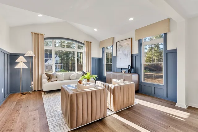 a living room with furniture a window and a chandelier