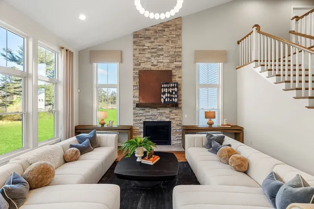 a living room with furniture and large windows
