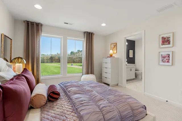 a spacious bedroom with a large bed and a window