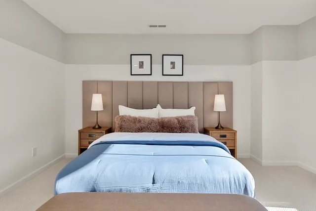 a bedroom with a large bed and a couch