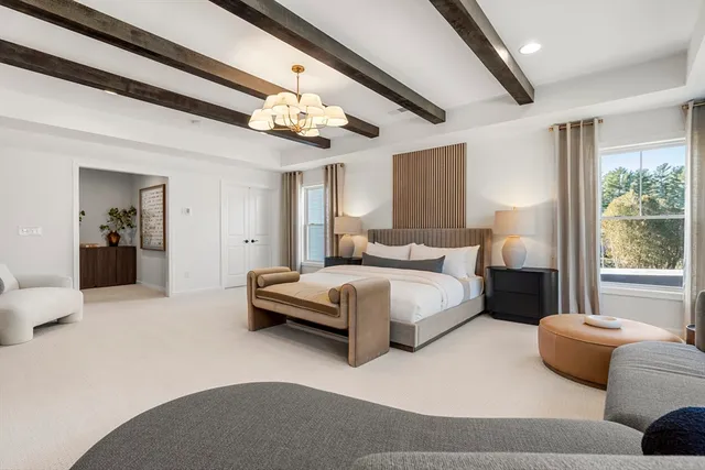 a large bed sitting in a bedroom next to a window