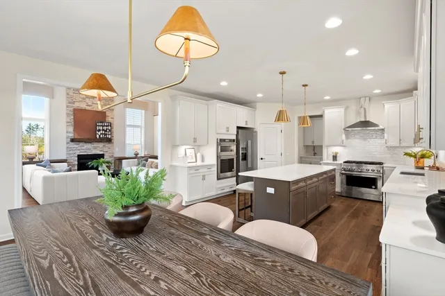 a view of a kitchen with a sink and dishwasher with wooden floor