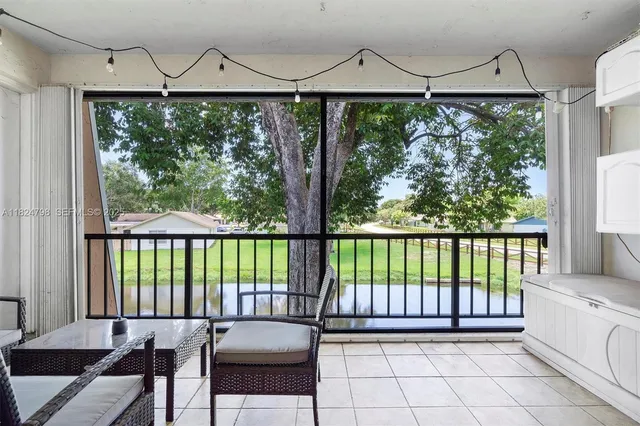 a view of a balcony with furniture and wooden floor