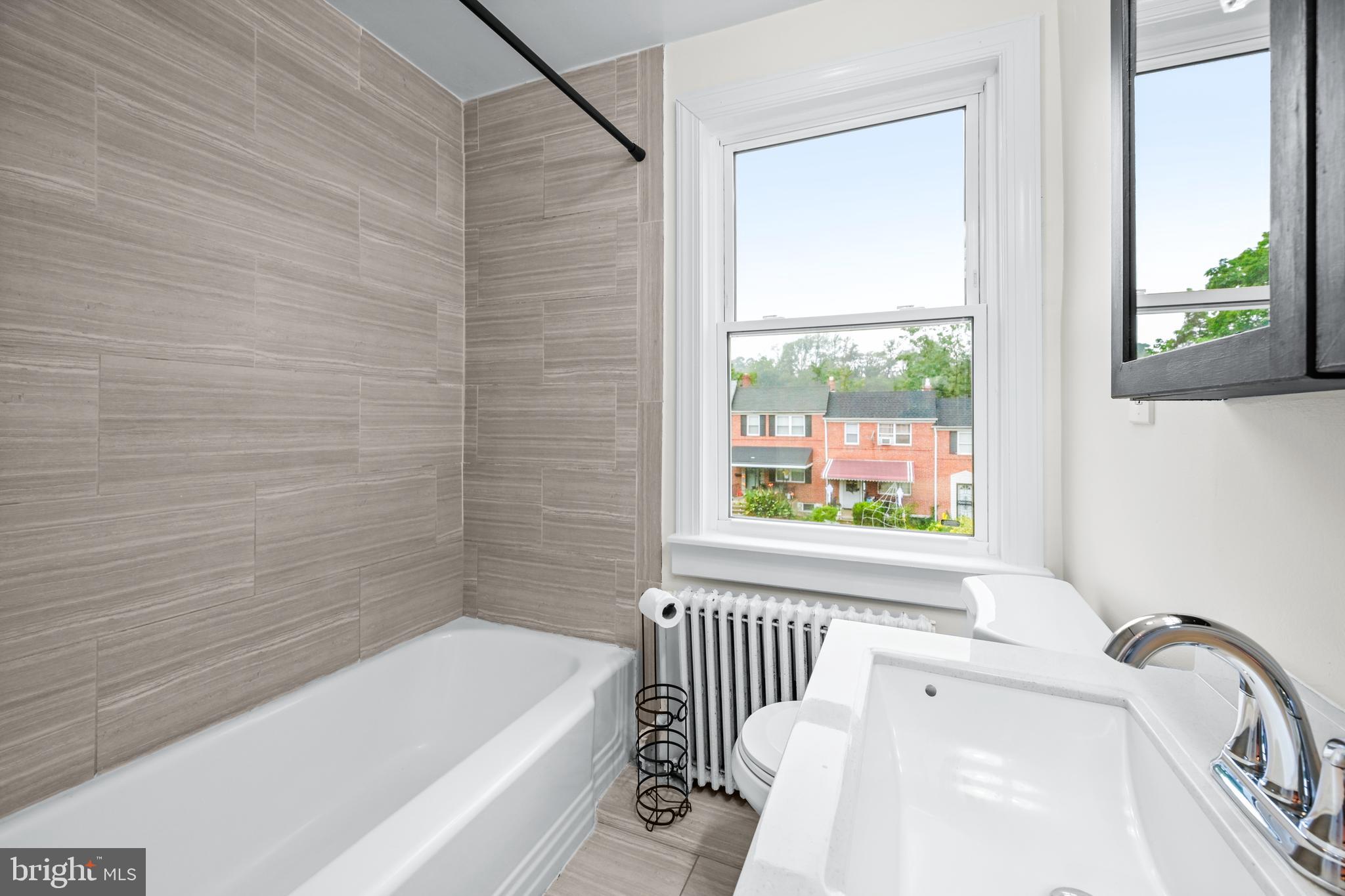 417 Random Road Baltimore, MD 21229 - Photo 12 of 32 a bathroom with a bathtub and a window