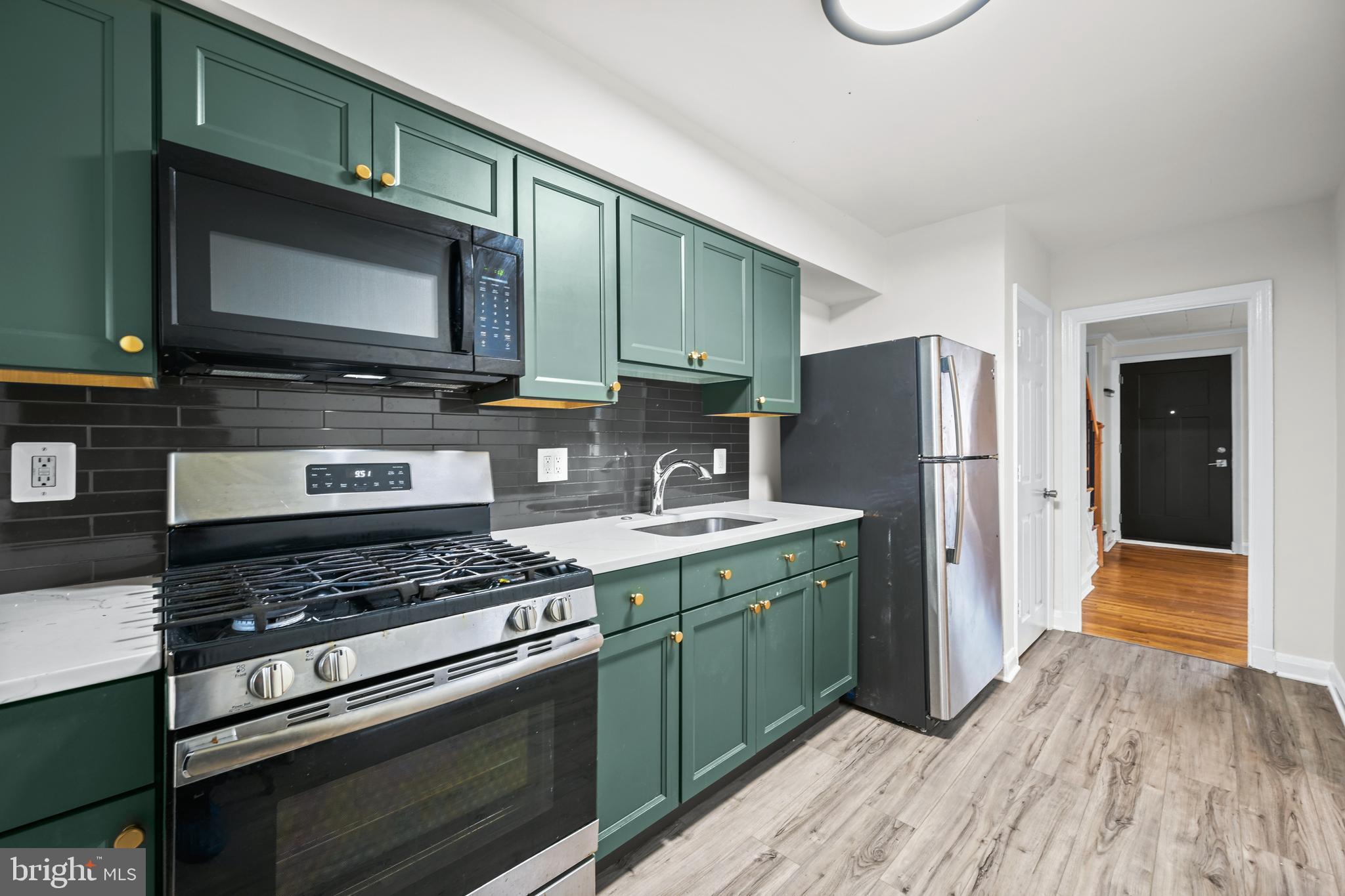 417 Random Road Baltimore, MD 21229 - Photo 2 of 32 a kitchen with a stove and a microwave