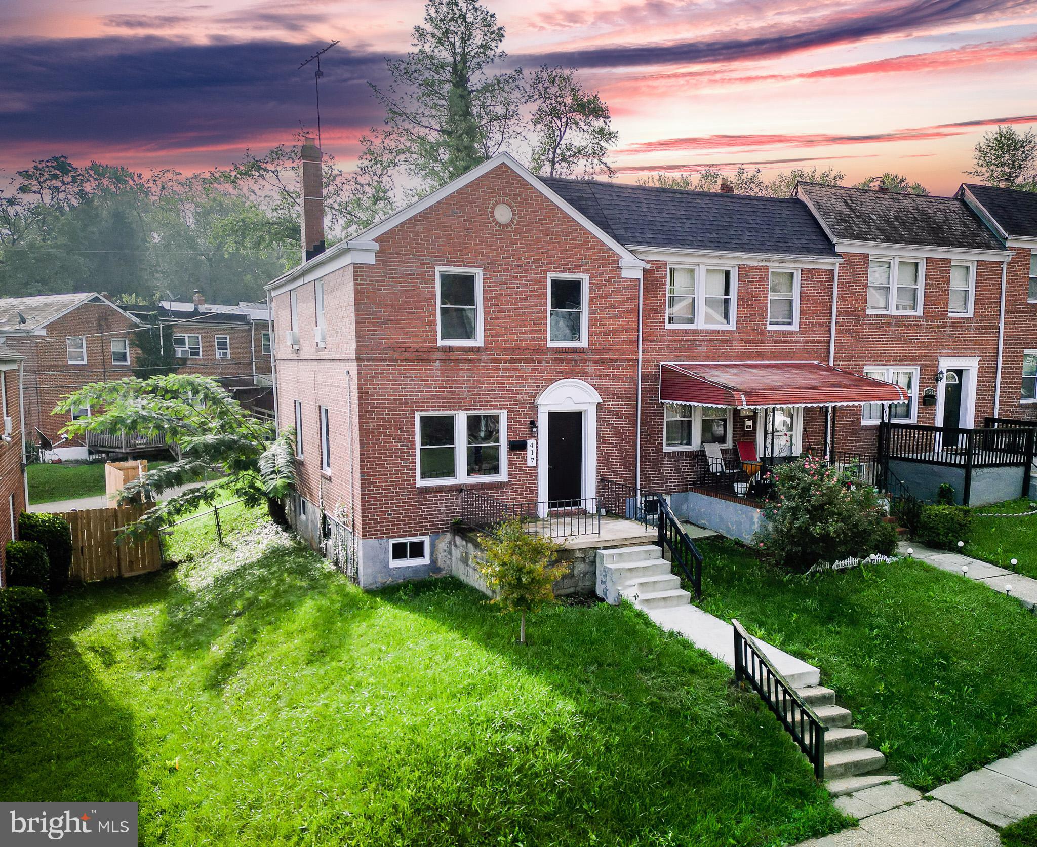 417 Random Road Baltimore, MD 21229 - Photo 22 of 32 a front view of a house with a yard and garage