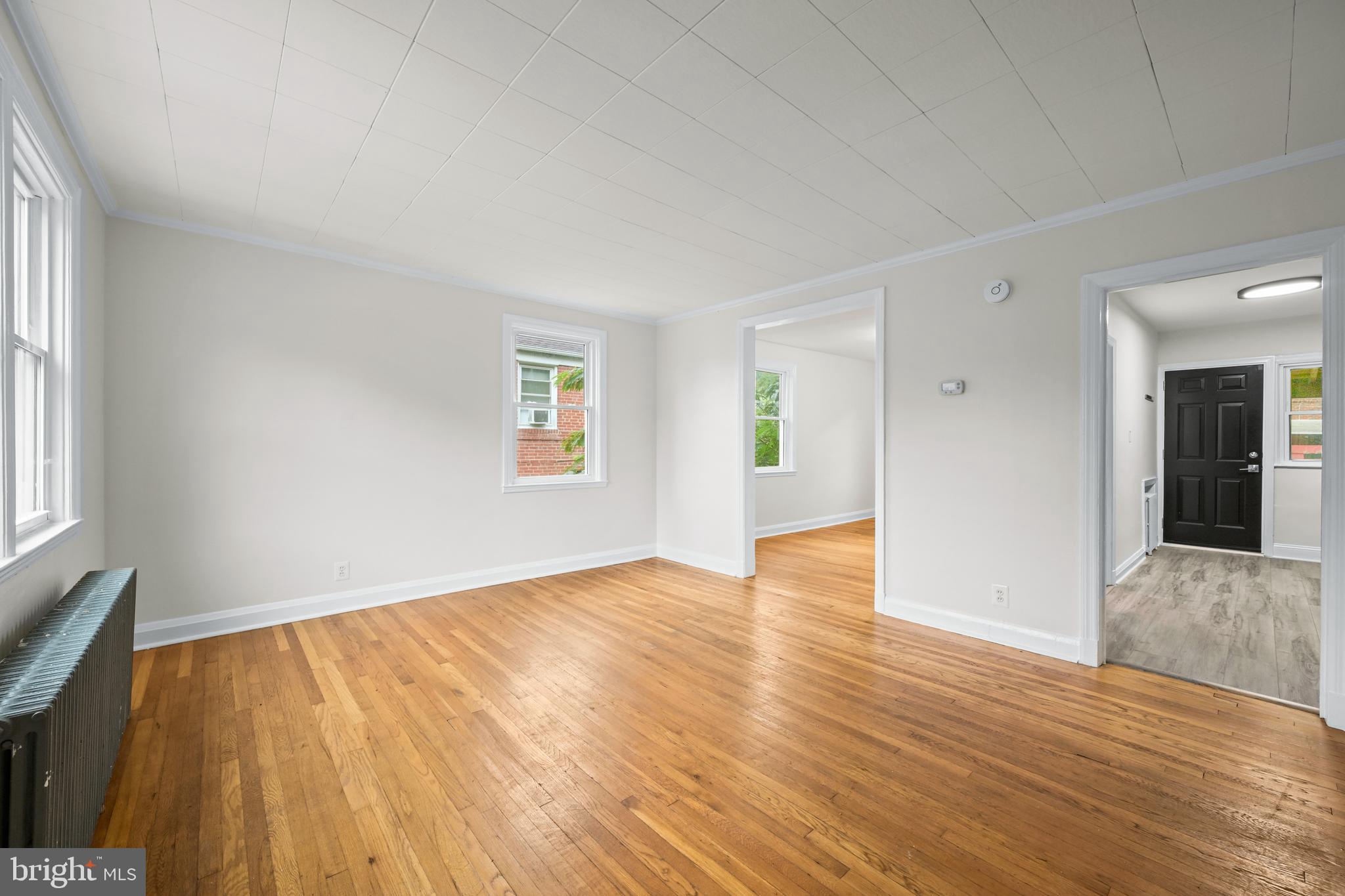 417 Random Road Baltimore, MD 21229 - Photo 5 of 32 a view of an empty room with wooden floor and a window