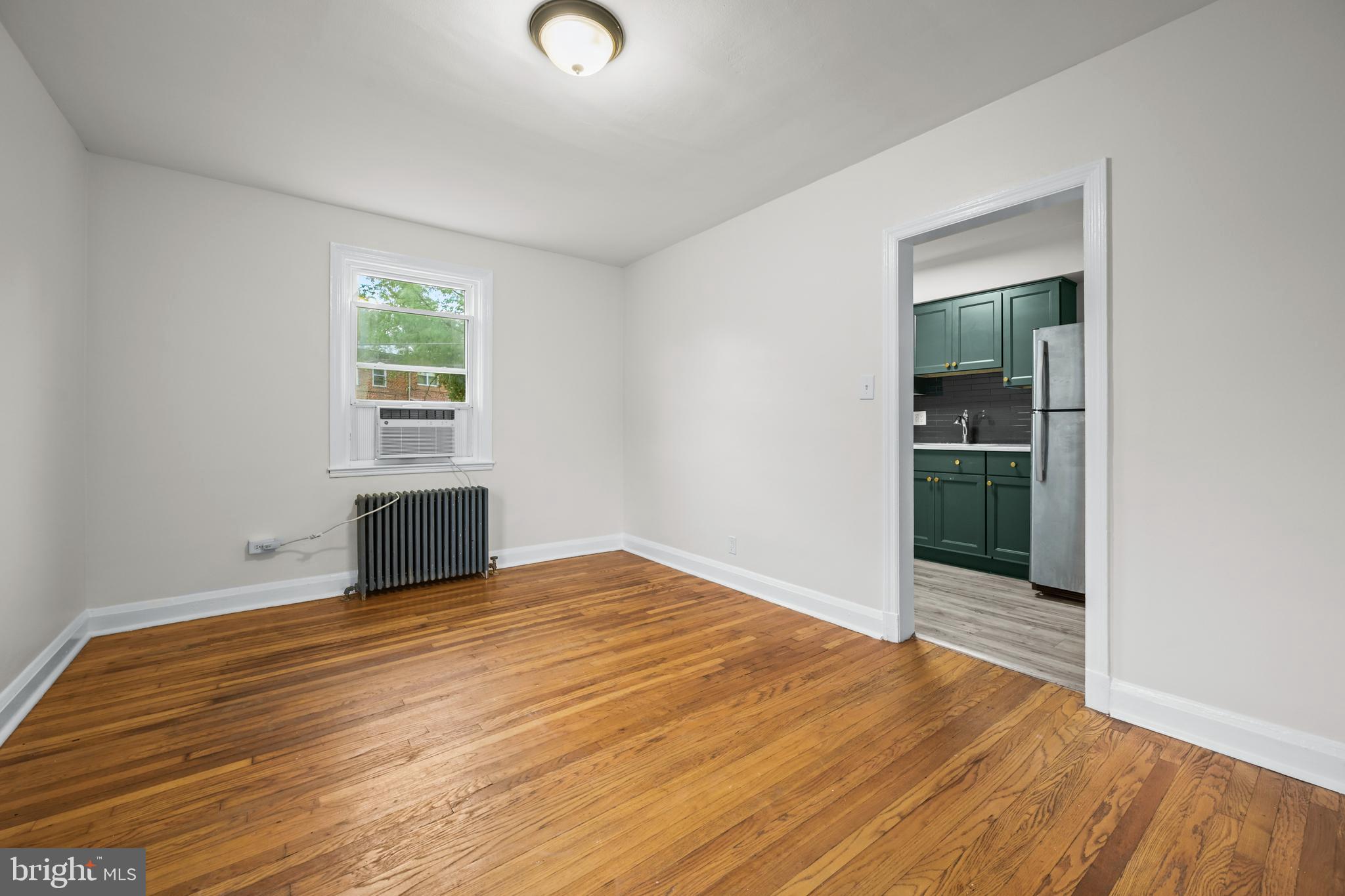 417 Random Road Baltimore, MD 21229 - Photo 9 of 32 an empty room with wooden floor and windows