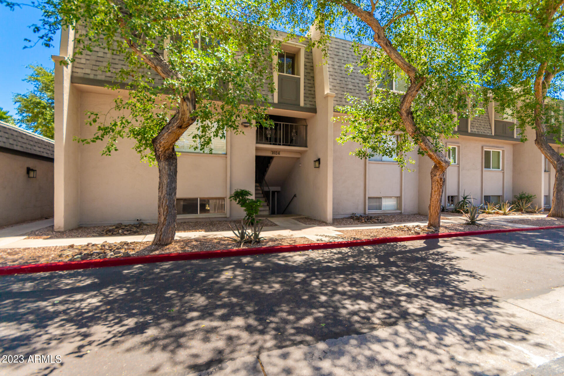 1024 East Osborn Road, Unit B Phoenix, AZ 85014 - Photo 1 of 21 a backyard of a house with table and chairs
