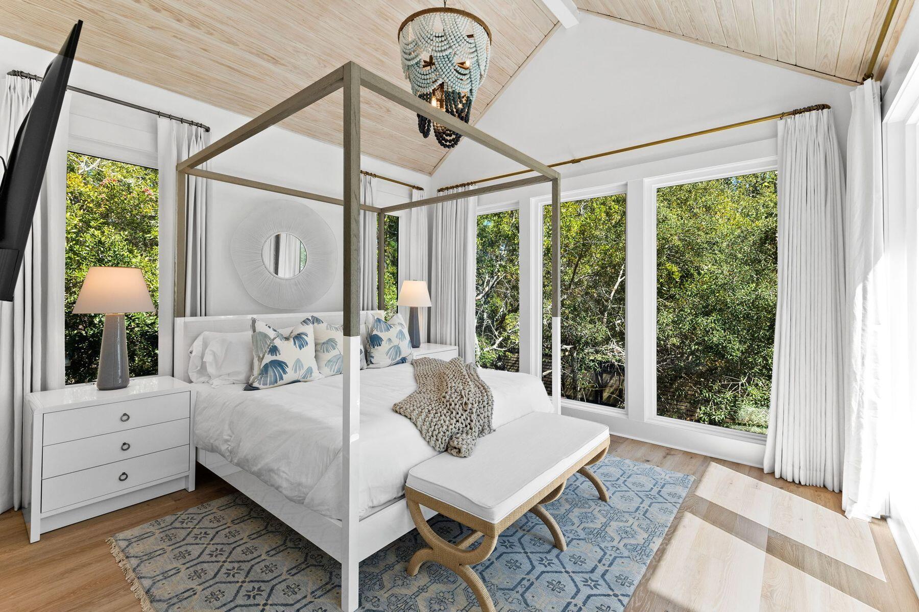 261 Defuniak Street Santa Rosa Beach, FL 32459 - Photo 18 of 27 a bedroom with a bed and large window