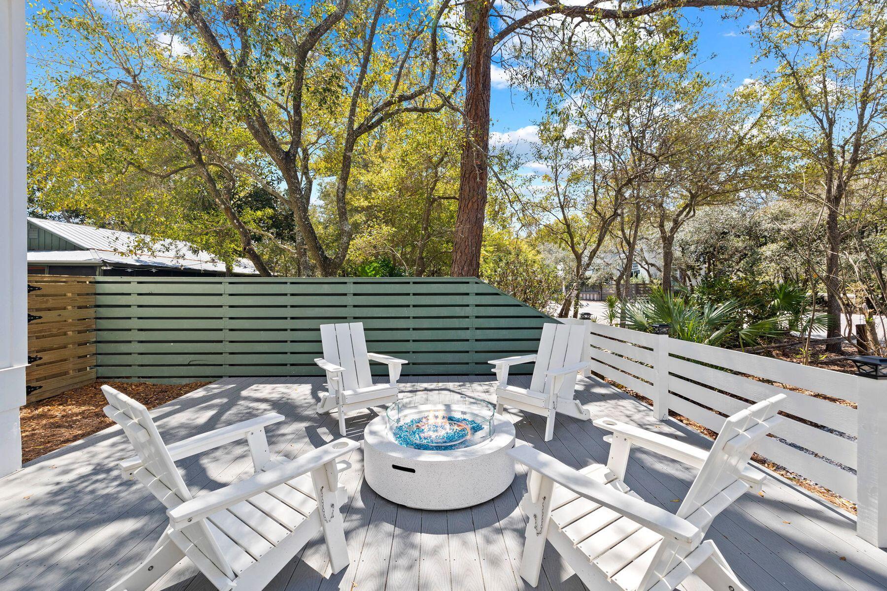 261 Defuniak Street Santa Rosa Beach, FL 32459 - Photo 2 of 27 a view of a patio with chairs and a potted plant