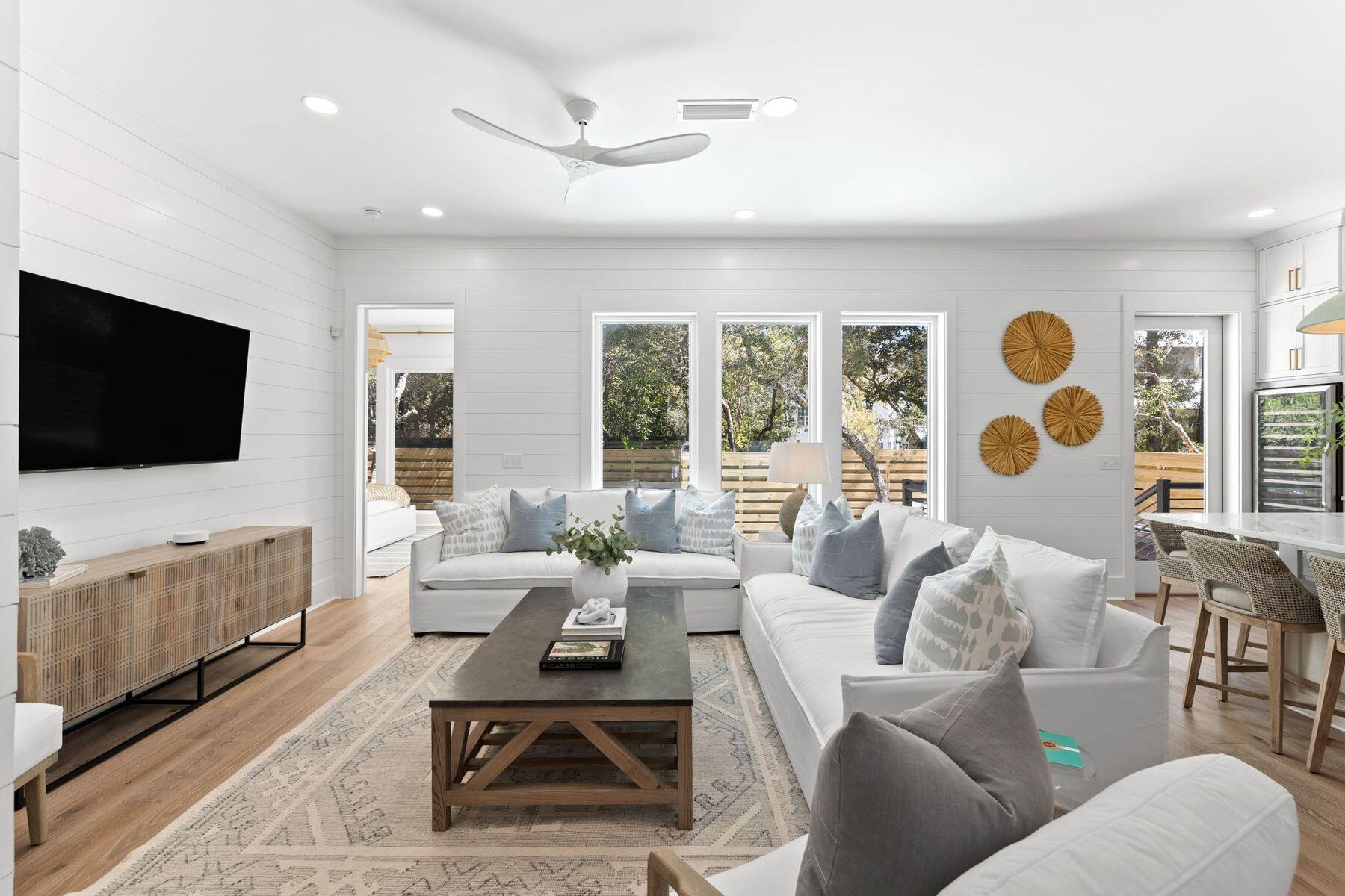 261 Defuniak Street Santa Rosa Beach, FL 32459 - Photo 7 of 27 a living room with furniture and a flat screen tv