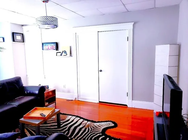 a blue room with furniture and a flat screen tv