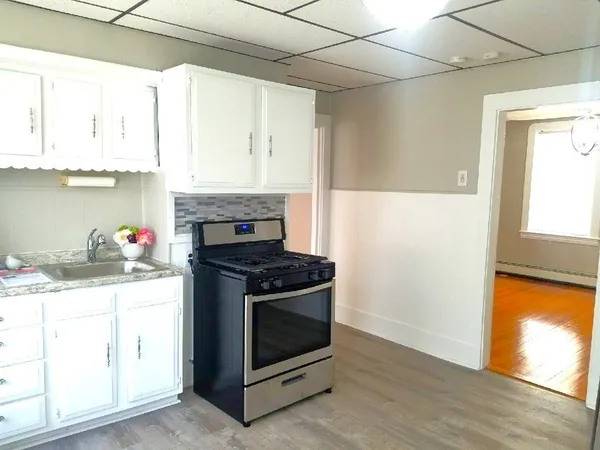 a kitchen with granite countertop a stove and a sink