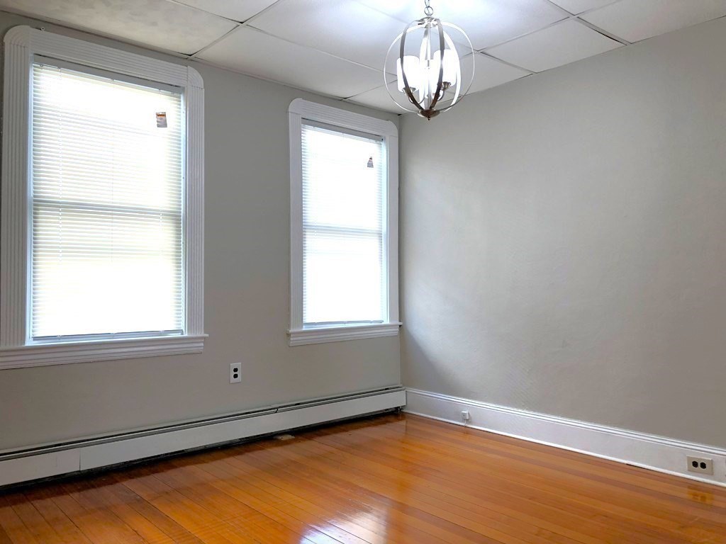 722 Adams Street, Unit 1 Boston, MA 02122 - Photo 6 of 10 a view of empty room with wooden floor and fan