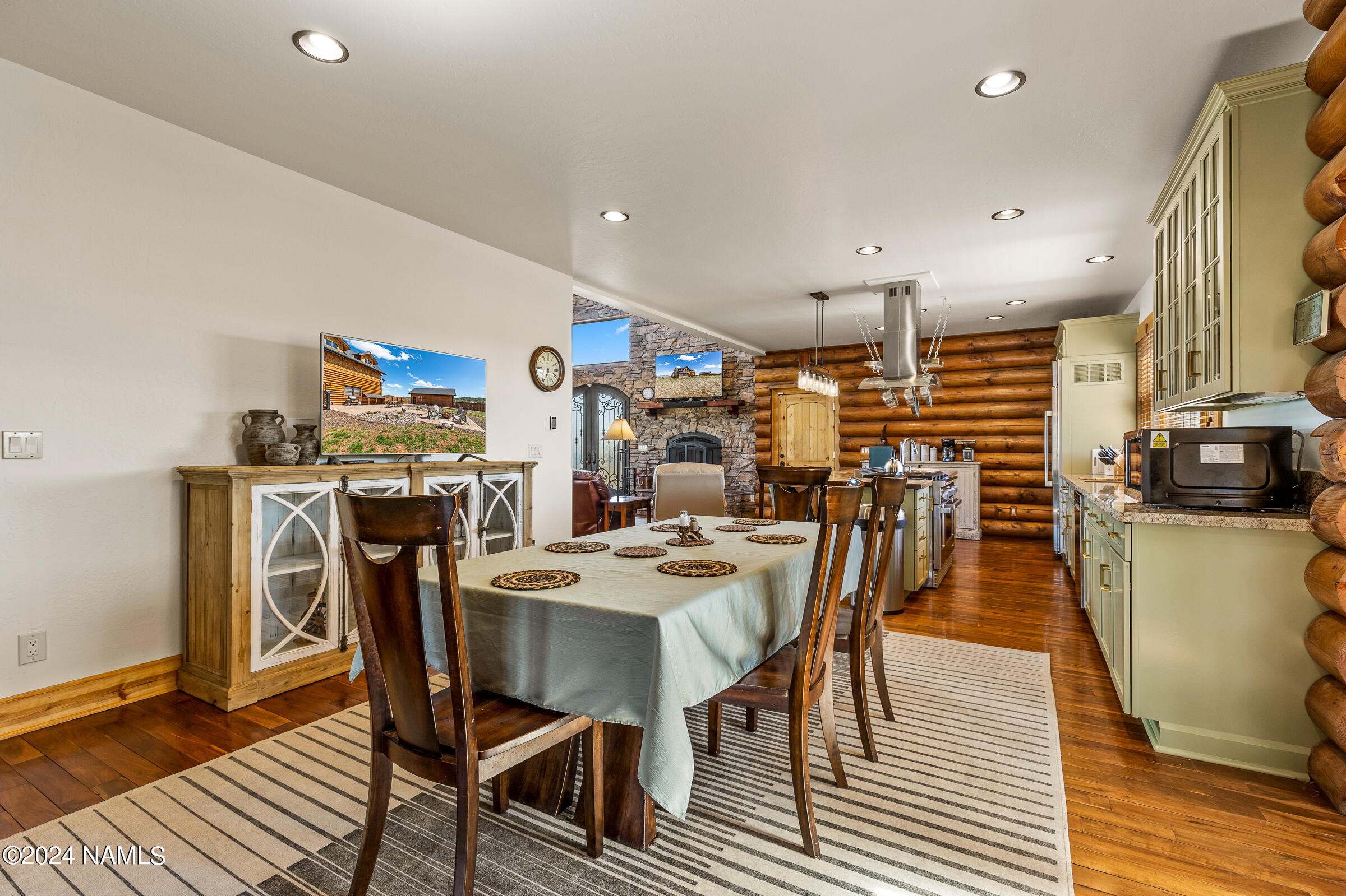 3130 North Spring Valley Road Parks, AZ 86018 - Photo 11 of 48 a dining area with stainless steel appliances kitchen island a table and chairs