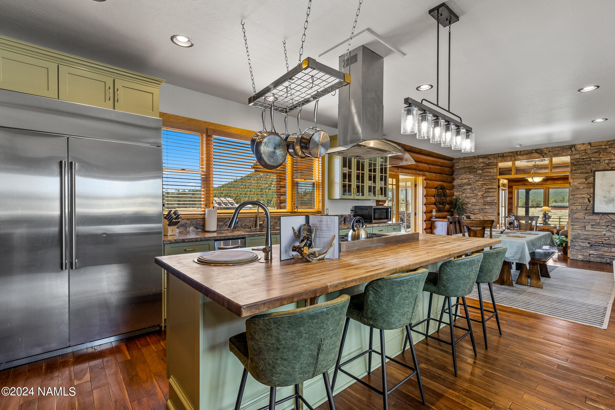 3130 North Spring Valley Road Parks, AZ 86018 - Photo 15 of 48 a kitchen with stainless steel appliances granite countertop a sink a stove and a wooden floors
