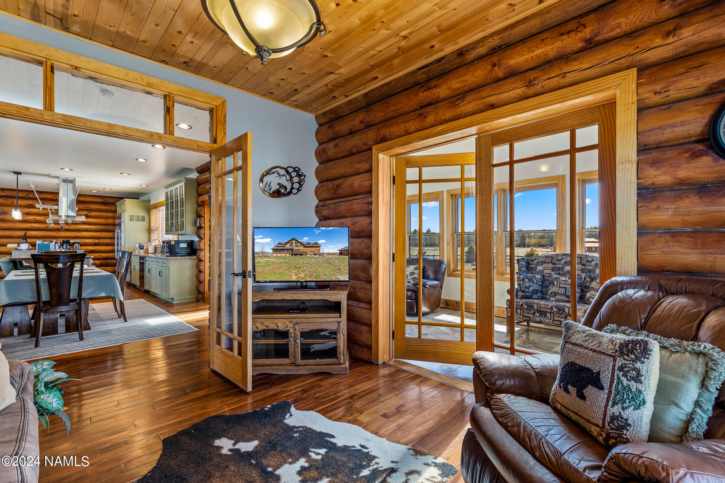 3130 North Spring Valley Road Parks, AZ 86018 - Photo 18 of 48 a living room with furniture a ceiling fan and a floor to ceiling window
