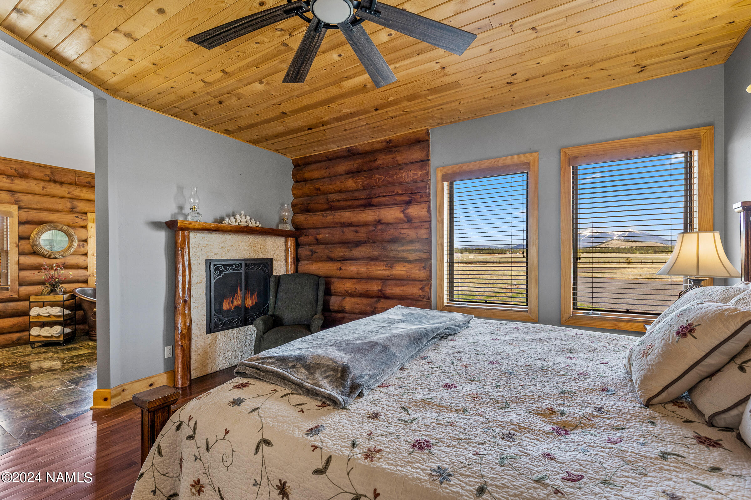 3130 North Spring Valley Road Parks, AZ 86018 - Photo 22 of 48 a bedroom with a bed and a fireplace
