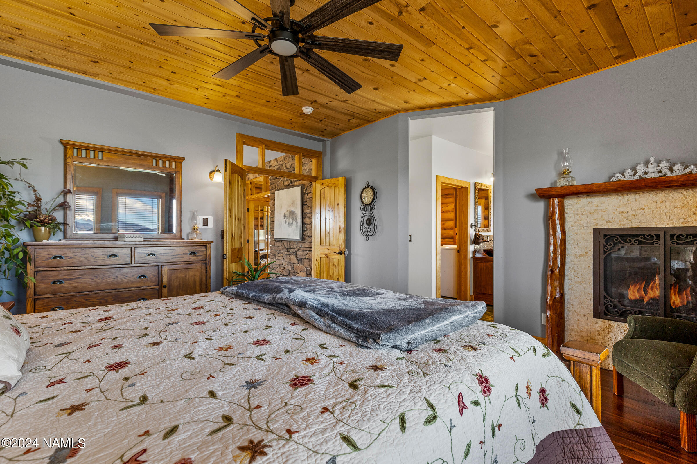 3130 North Spring Valley Road Parks, AZ 86018 - Photo 23 of 48 a bedroom with a bed a dresser and potted plants