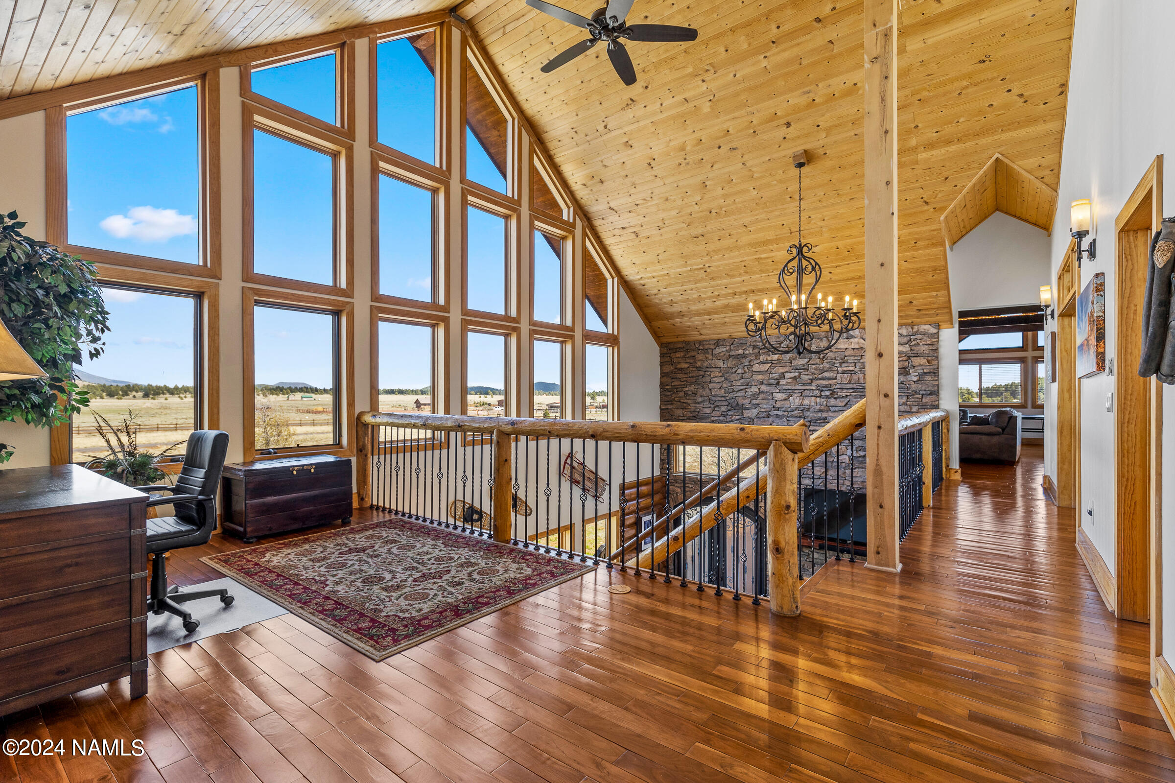 3130 North Spring Valley Road Parks, AZ 86018 - Photo 31 of 48 a living room with a rug floor to ceiling windows and an outdoor view