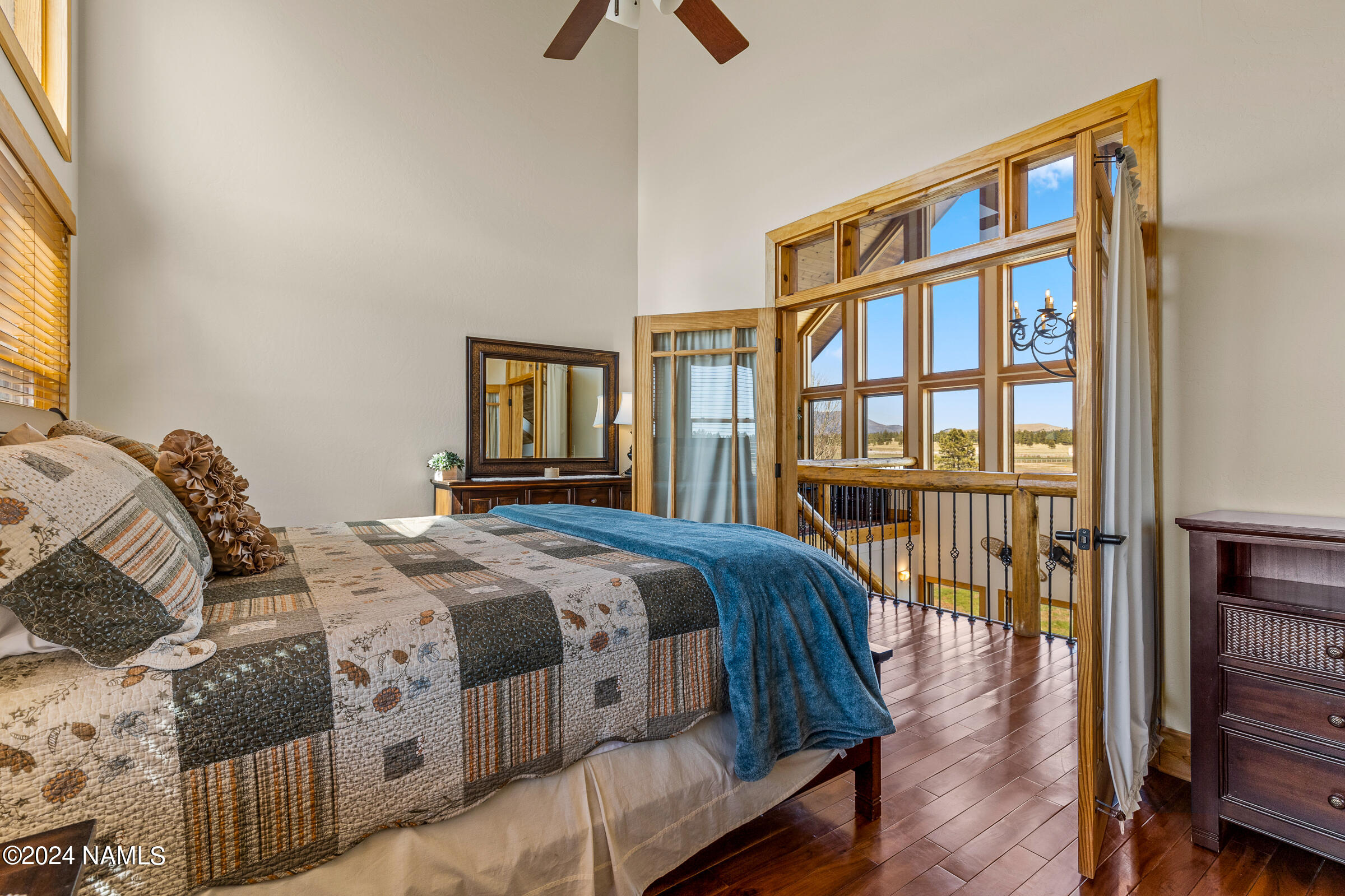 3130 North Spring Valley Road Parks, AZ 86018 - Photo 35 of 48 a bedroom with a bed a couch and a large window