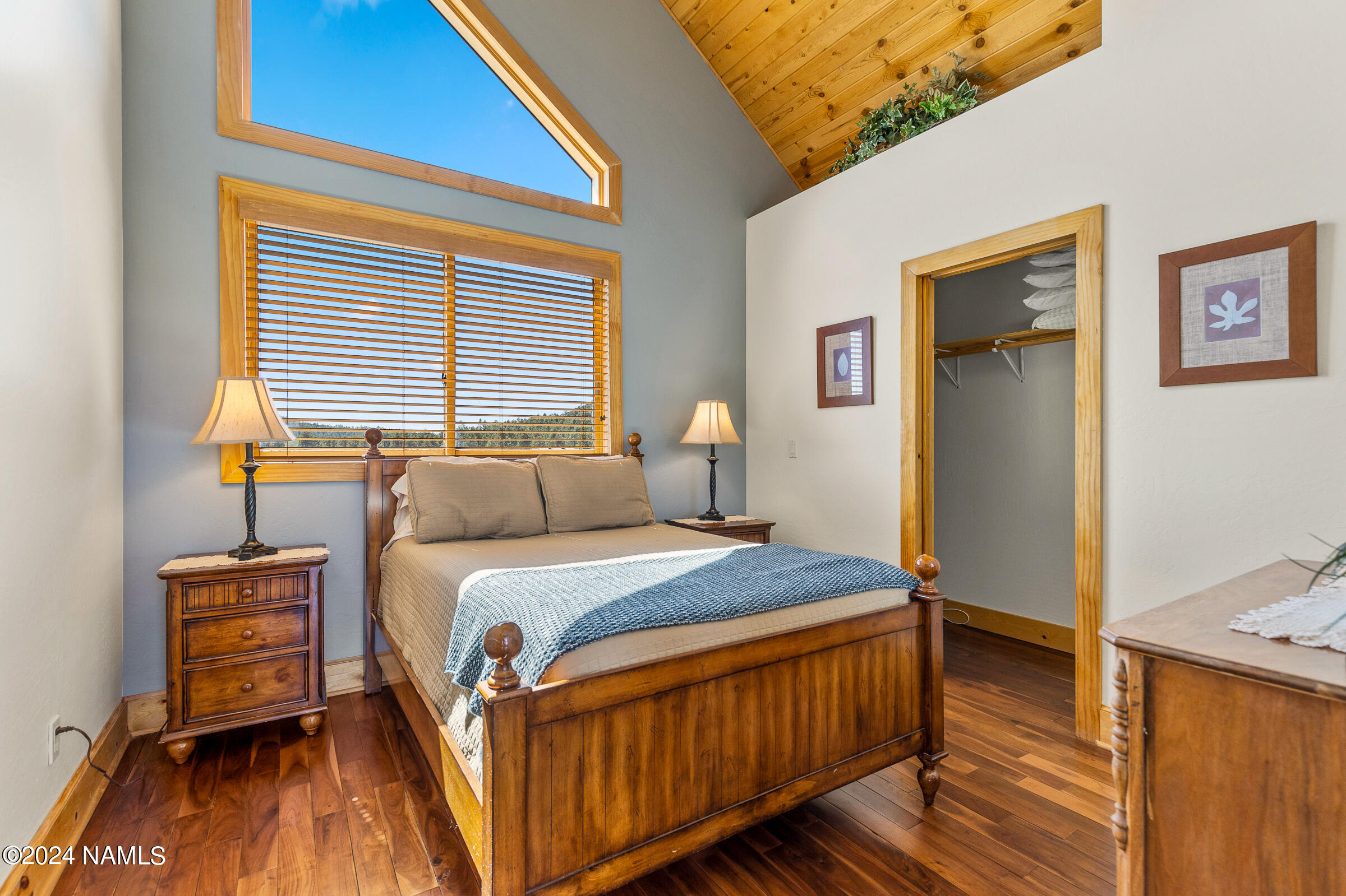 3130 North Spring Valley Road Parks, AZ 86018 - Photo 36 of 48 a bedroom with a bed and wooden floor