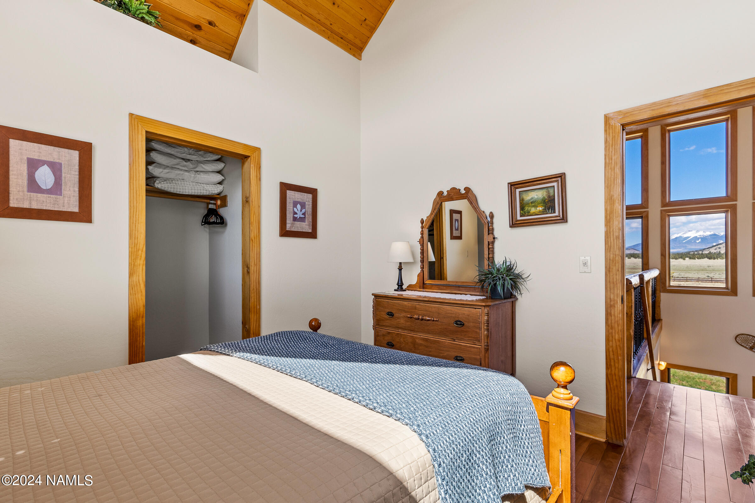 3130 North Spring Valley Road Parks, AZ 86018 - Photo 37 of 48 a bedroom with a bed and wooden floor
