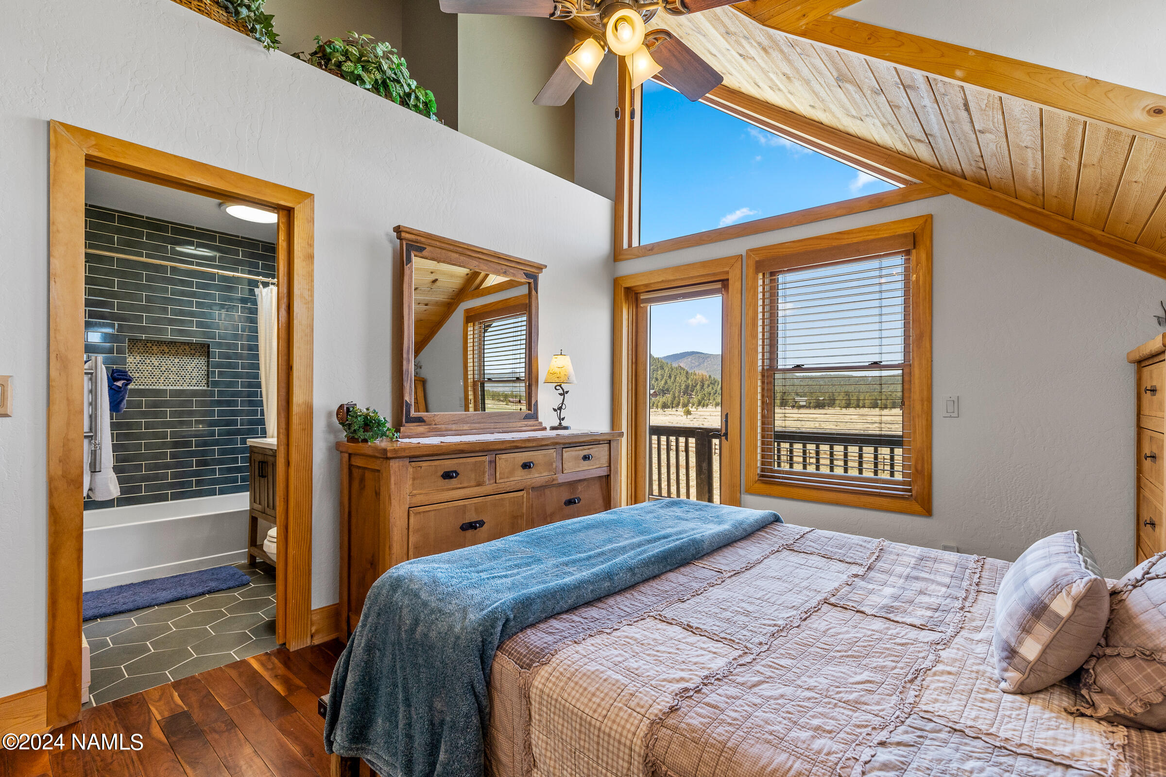 3130 North Spring Valley Road Parks, AZ 86018 - Photo 44 of 48 a bedroom with a bed and a large window with balcony view