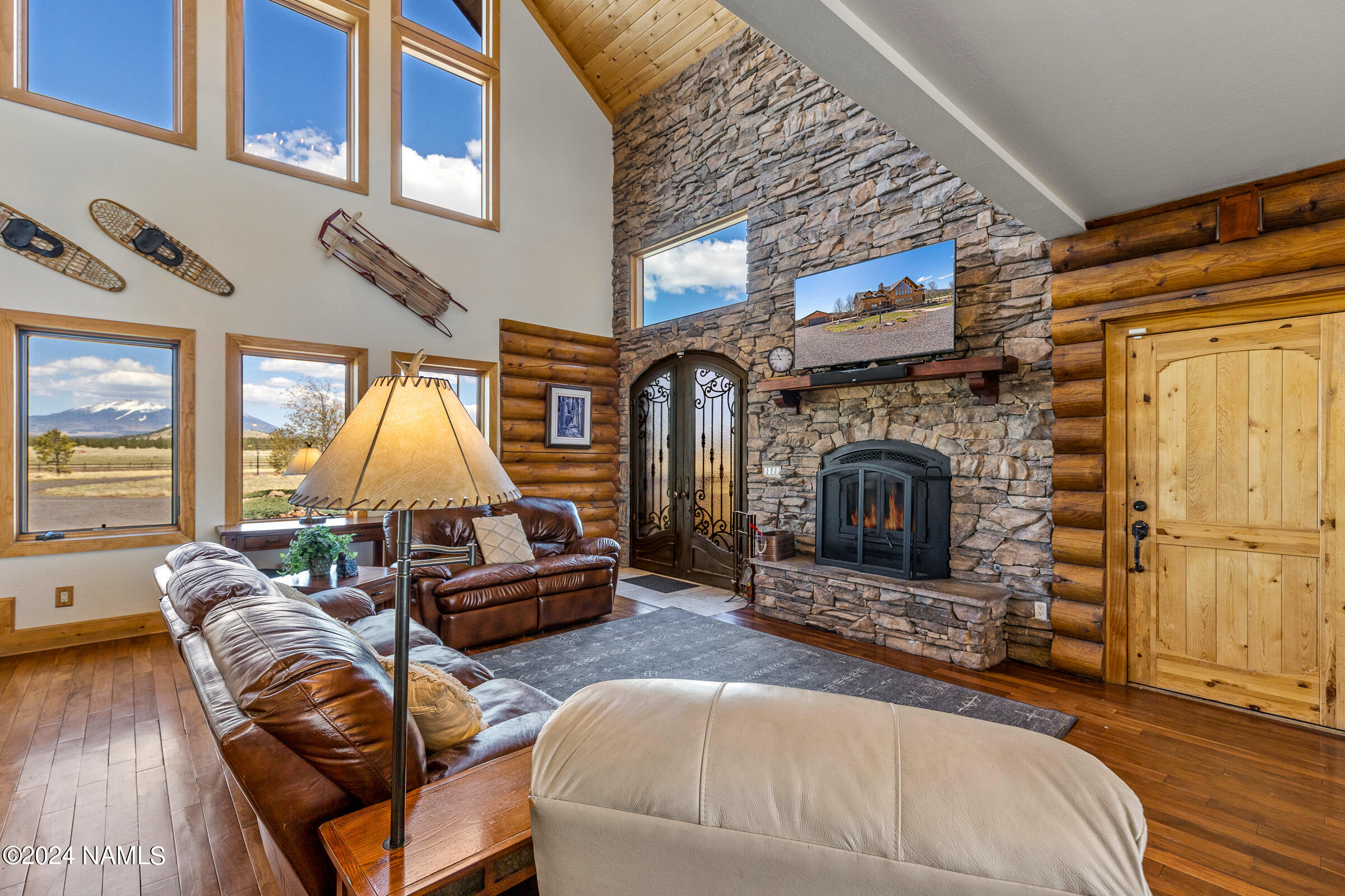 3130 North Spring Valley Road Parks, AZ 86018 - Photo 8 of 48 a living room with furniture a fireplace and a large window