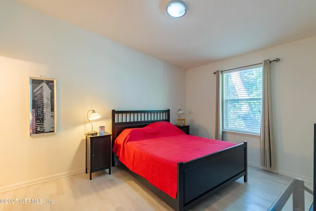 a bedroom with a bed and window