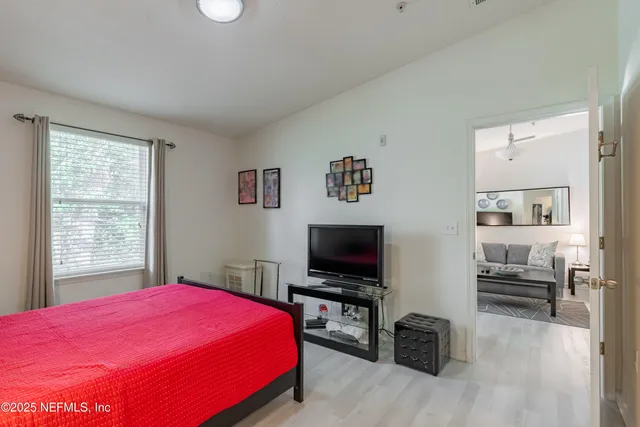 a bedroom with a bed and a flat screen tv