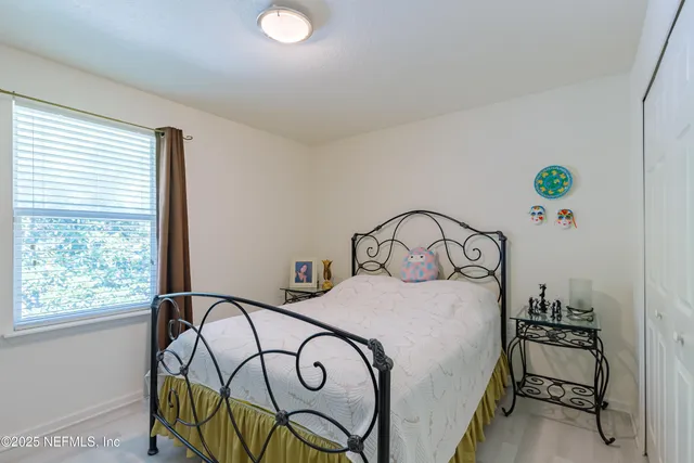 a bedroom with a bed and a table