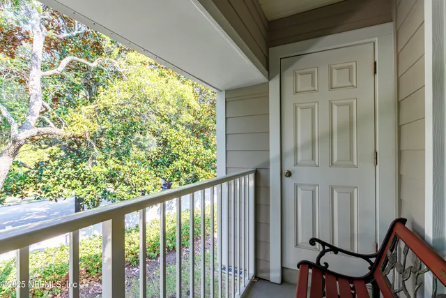 a view of a balcony with chair and table in the patio