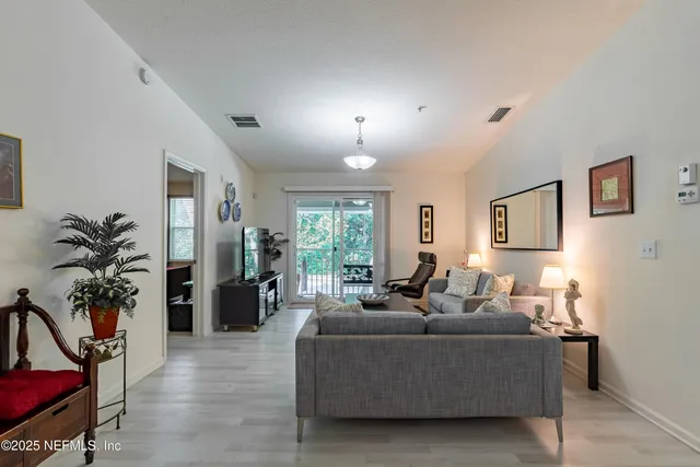 a living room with furniture potted plant and a window