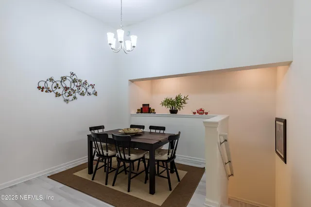 a view of a dining room with furniture and chandelier